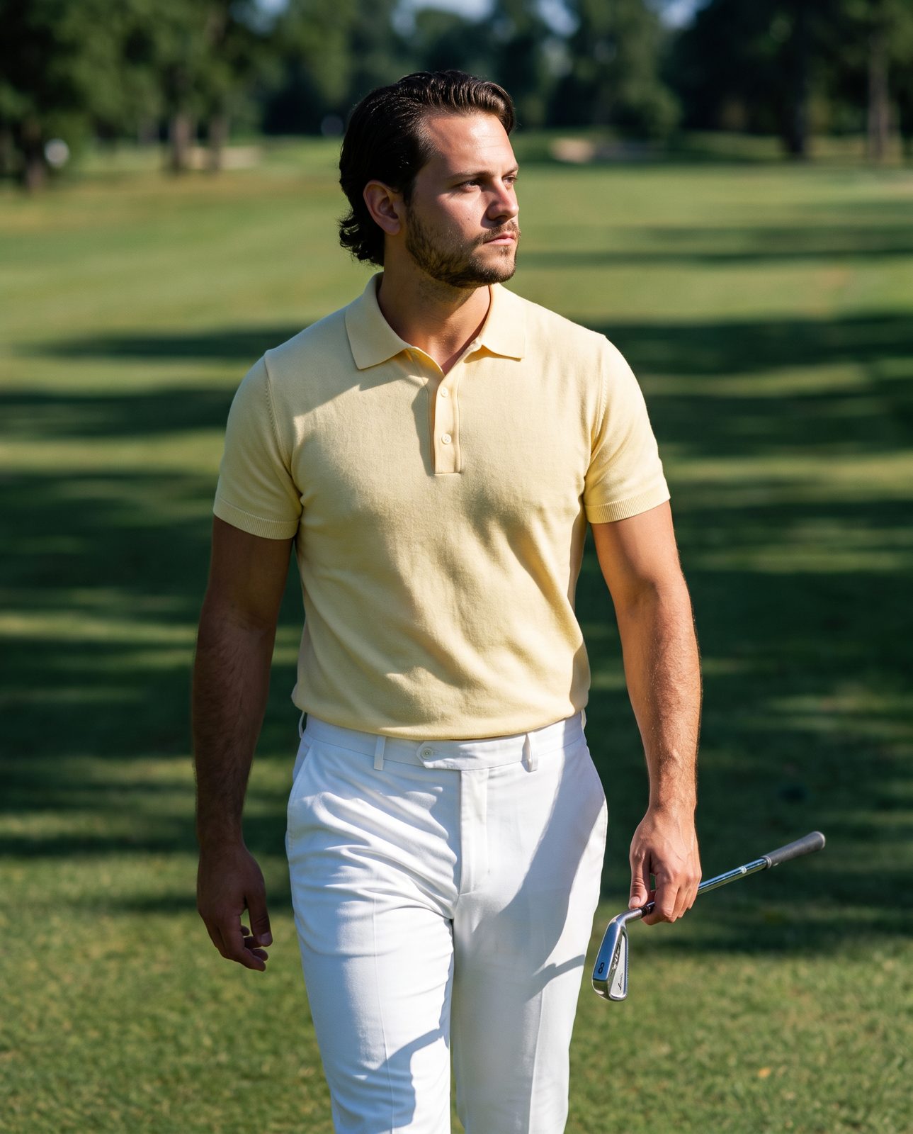 Golfer in a Sunday yellow wool polo walking the fairway